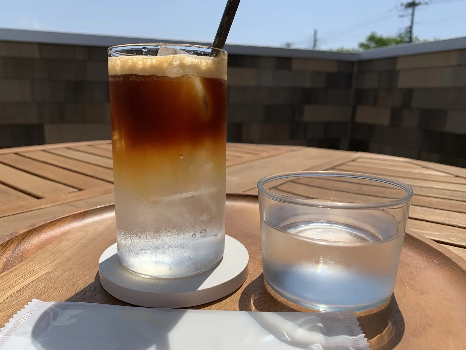 Dark cold-brew coffee layered over a clear sparkling tonic drink