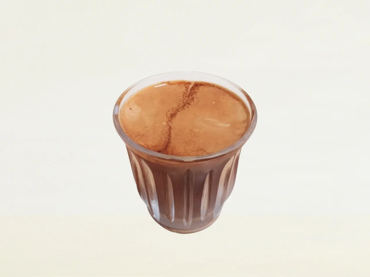 Dirty Coffee in a small clear glass with hot coffee meeting cold milk