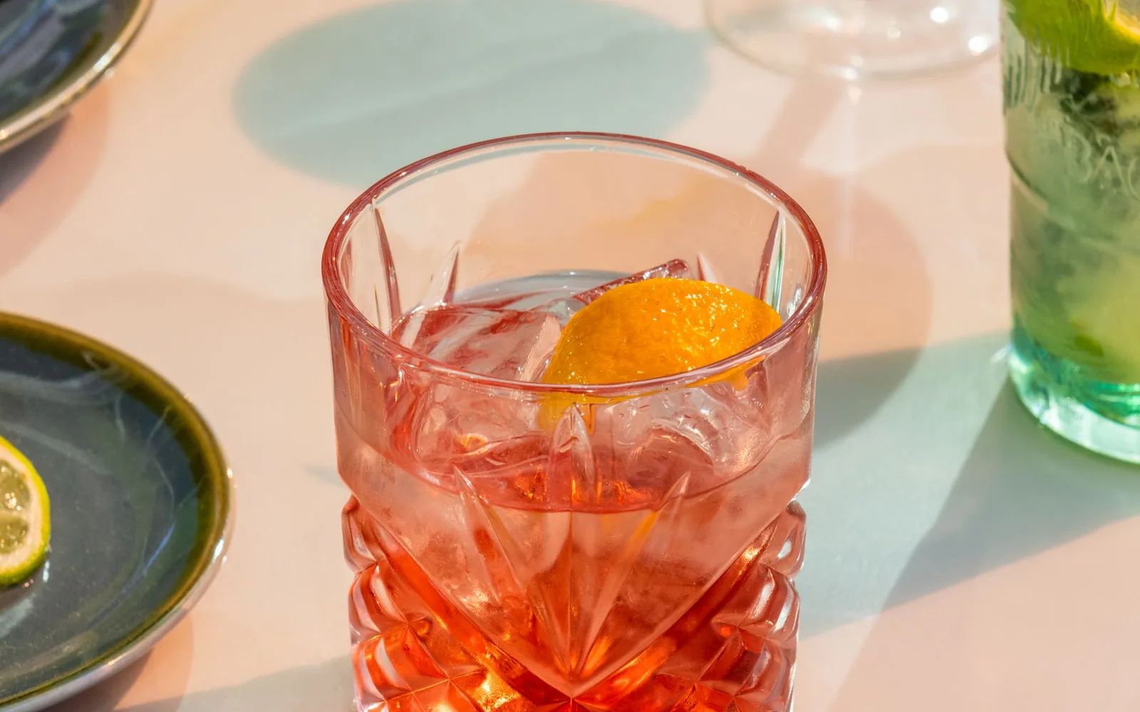 一杯橙红色 Negroni 鸡尾酒，杯中有冰块